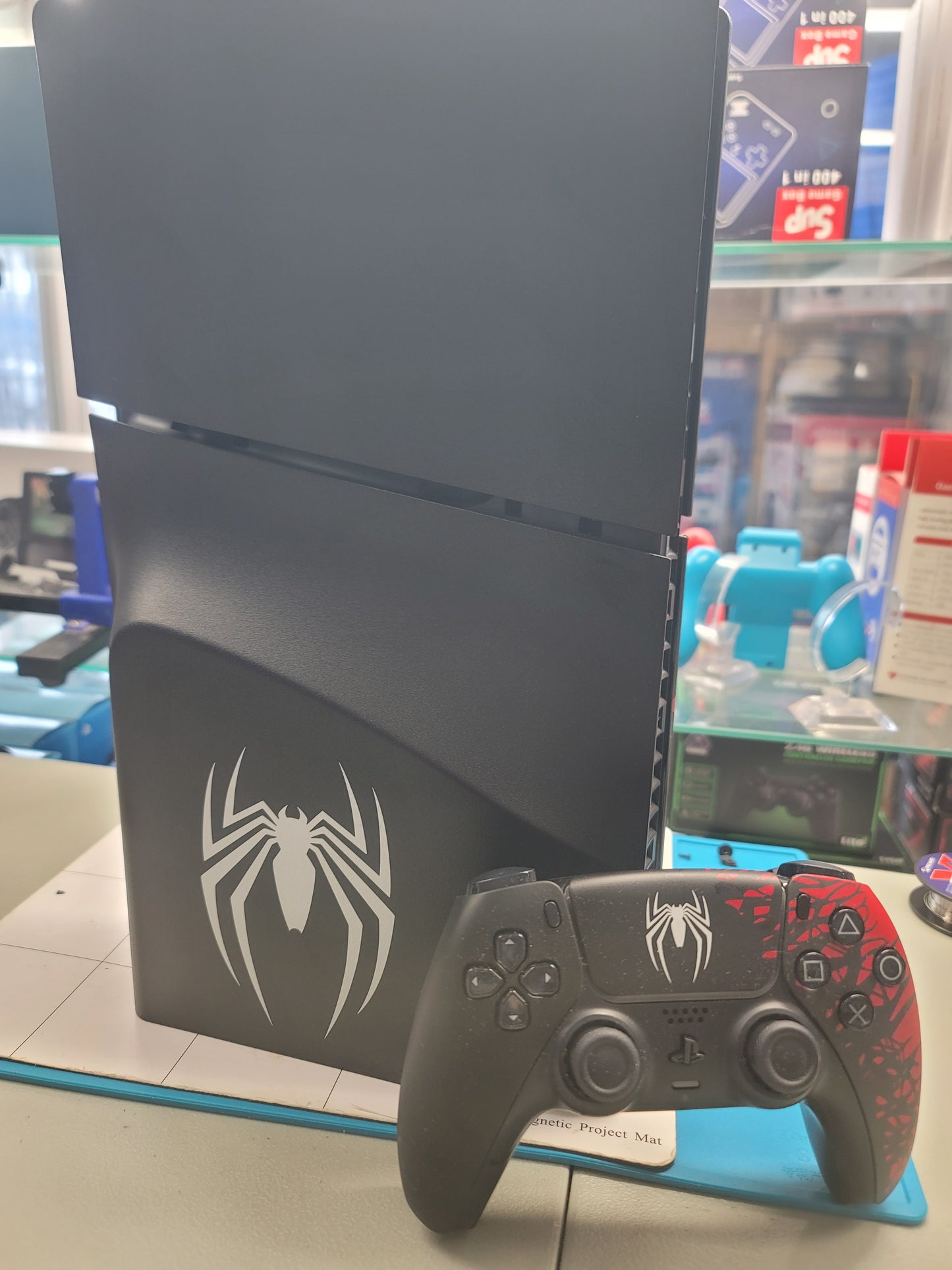 PS5 Slim Blu-Ray Edition Spider-Man Console with Spider-Man controller.